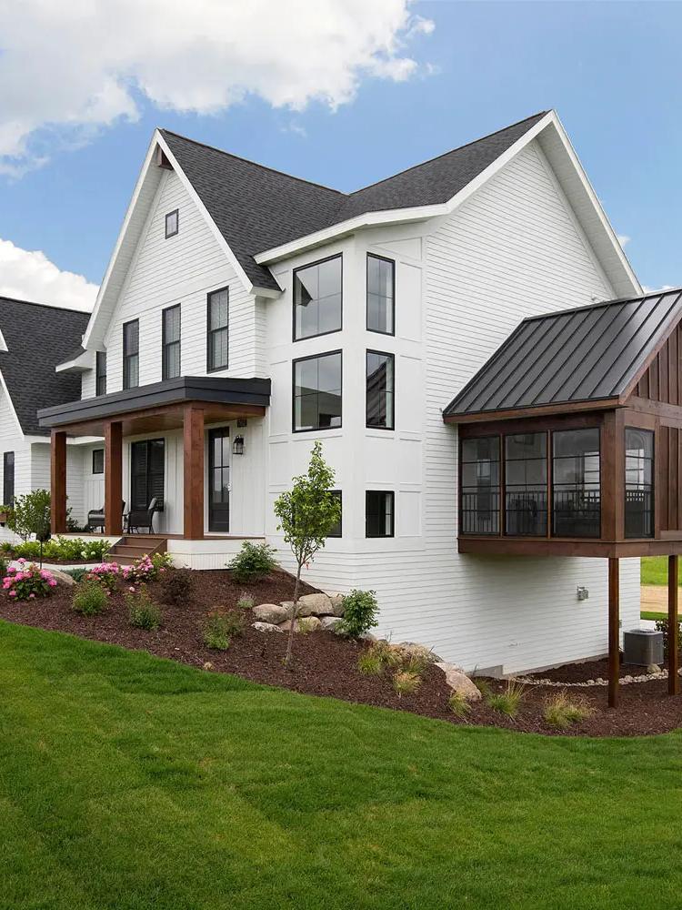 White farmhouse with freshly painted trim and fascia