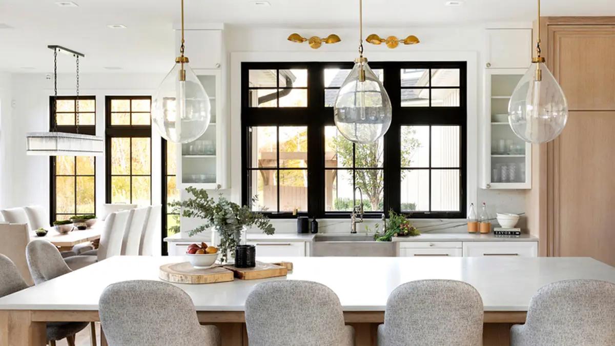 Kitchen with black-framed windows, white oak island and brass pendant lighting