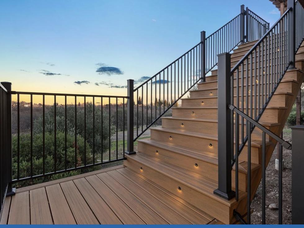 Composite deck and stair with black steel railing and integrated riser lighting